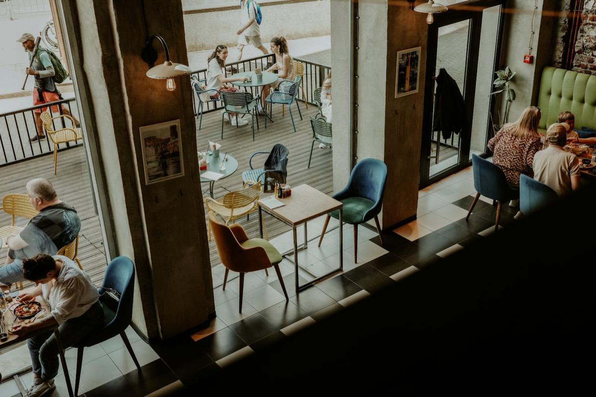 Guests at tables on a busy café floor